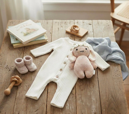 Baby girl's white knitted cotton long-sleeved romper